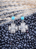 Dangle earrings shown on beans and wheat