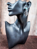Mannequin wearing dangle earring
