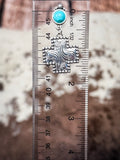 Dangle earring shown on ruler for size