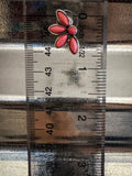 stud earring on ruler