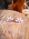 stud earrings on wood table