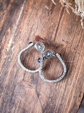 stirrup earring on wood