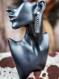earrings on mannequin