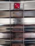red dice earring on ruler