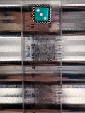 blue dice earring on ruler
