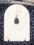 stud earring on small ruler, beans, and wheat