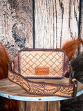 fanny pack on wood table, feathers on background, wood backdrop
