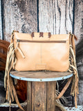 back of bag on wood table, feathers and wheat in background, wood backdrop