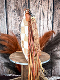 side of bag on wood table, feathers and wheat in background, wood backdrop