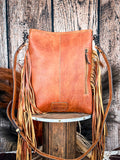 back of bag on wood table, feathers and wheat in background, wood backdrop