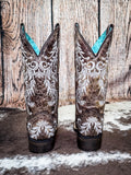 back of boots on cowhide, wood backdrop