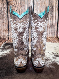back of boots on cow hide, wood backdrop