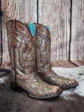 boots on cow hide, wood backdrop