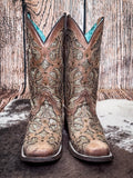 front of boots on cowhide, wood backdrop