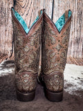 back of boots on cowhide, wood backdrop