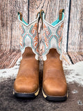 front of boots on cowhide, wood backdrop