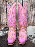 front of boots on cowhide, wood backdrop