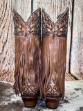 back of boots on cowhide, wood backdrop