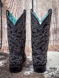 back of boots on cowhide, wood backdrop