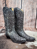 side of boots on cowhide, wood background