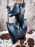 Earrings displayed on mannequin. 