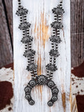 Necklace displayed on wood.