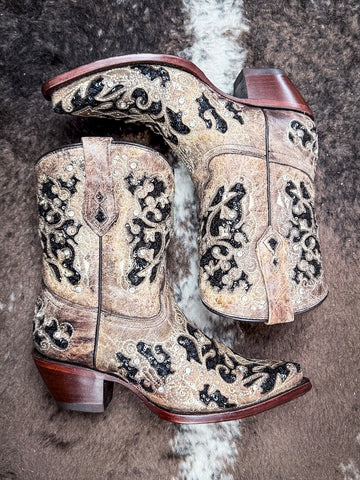 Boots displayed on cowhide.