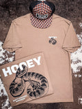 Front and back design of the Rattler Hooey T-Shirt displayed on cow hide with a hat.