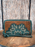 
Front view of the Electric Desert Wristlet Wallet on a wood table, wood back drop.