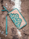Front of Electric Desert Wristlet Wallet displayed on cow hide. 