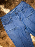 Close up of boot cut jeans front pockets.