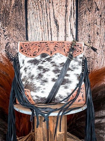 Front view of the Tumbleweed Trail Crossbody on a wood backdrop.