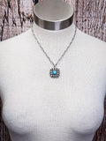 The Aster Pendant Necklace displayed on a mannequin