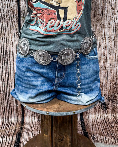 Luna Bloom Concho Chain Belt on a mannequin. 