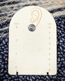 Prairie Petals Stud Fashion Earring on a ruler, displayed on beans and wheat.