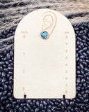 Prairie Petals Stud Fashion Earring on a ruler, displayed on beans and wheat.