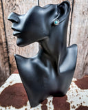 Prairie Petals Stud Fashion Earring on a mannequin, sitting on cowhide, wood backdrop.