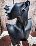 Prairie Petals Stud Fashion Earring on a mannequin, sitting on cowhide, wood backdrop.