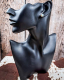 Prairie Petals Stud Fashion Earring on a mannequin, sitting on cowhide, wood backdrop.