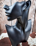 Sky and Stone Stud Fashion Earring Set on a mannequin, sitting on cowhide, wood back drop.