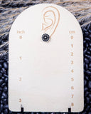 Sky and Stone Stud Fashion Earring on a ruler, displayed on beans and wheat.