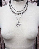 Three Trails Squash Blossom Fashion Necklace shown on a mannequin,