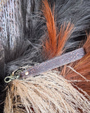 Classic Country Hand-Tooled Key Fob displayed on wheat, wood back drop.