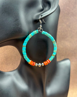 Turquoise and orange beaded hoop earring displayed on a black mannequin head. The hoop features turquoise-blue beads, orange-red beads, and small silver spacer beads, with a silver fishhook ear wire.