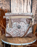 Front view of the Azure Aesthetic Leather & Hairon Bag on a wood table, wood backdrop.