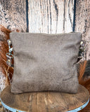 Back view of the Azure Aesthetic Leather & Hairon Bag on a wood table, wood backdrop.