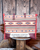 Front view of the Rio Vintage Clothing Weekender Bag on a wood table with a wood back drop.