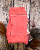 Side view of the Rio Vintage Clothing Weekender Bag on a wood table with a wood back drop.