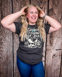 Model wearing the Cowboys Never Die Distressed Graphic Tee with a white back drop.