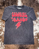 The Cowgirl Gang Vintage Graphic Tee displayed on cowhide.